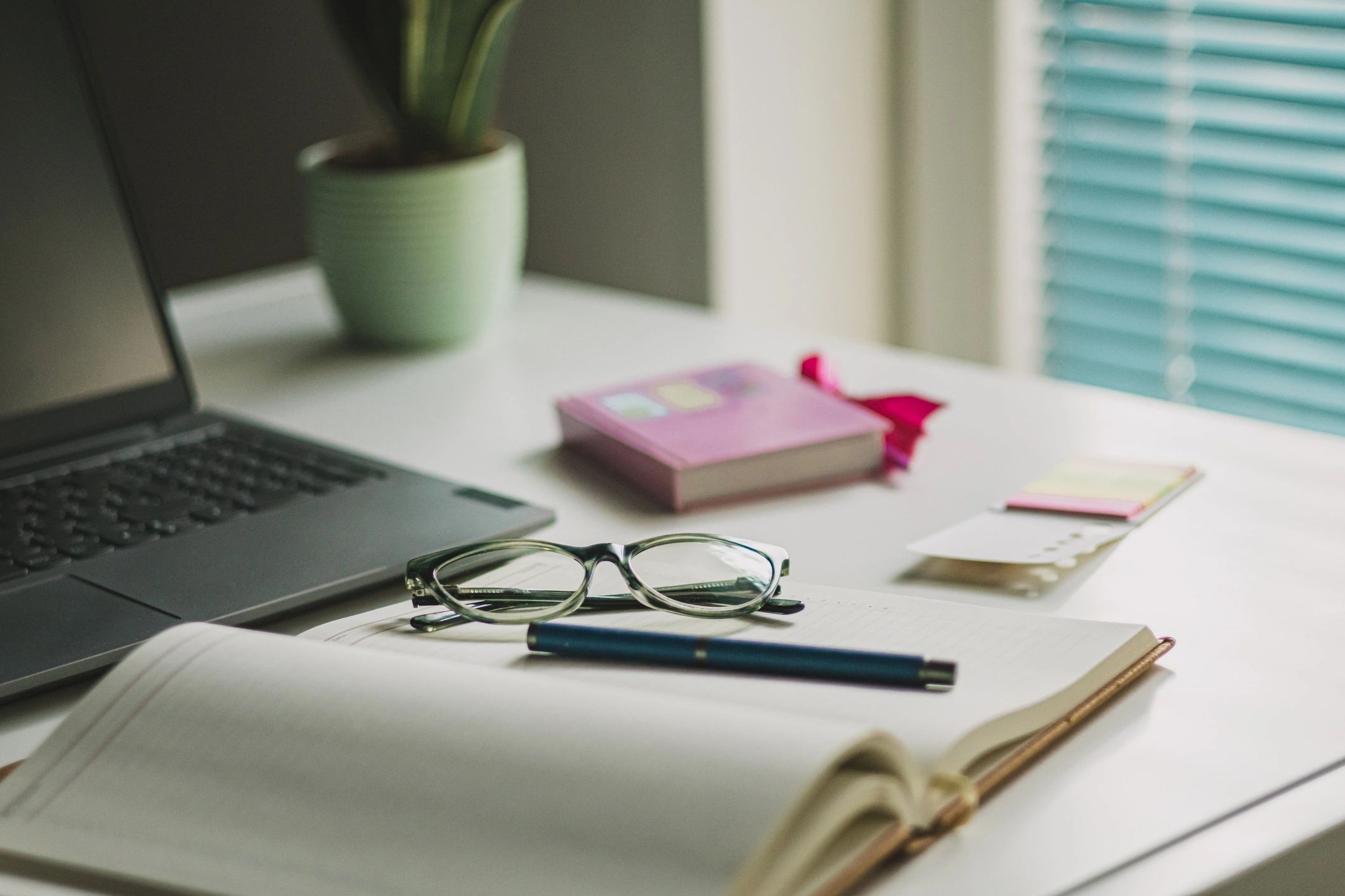 Professional office desk with laptop, coffee, and documents