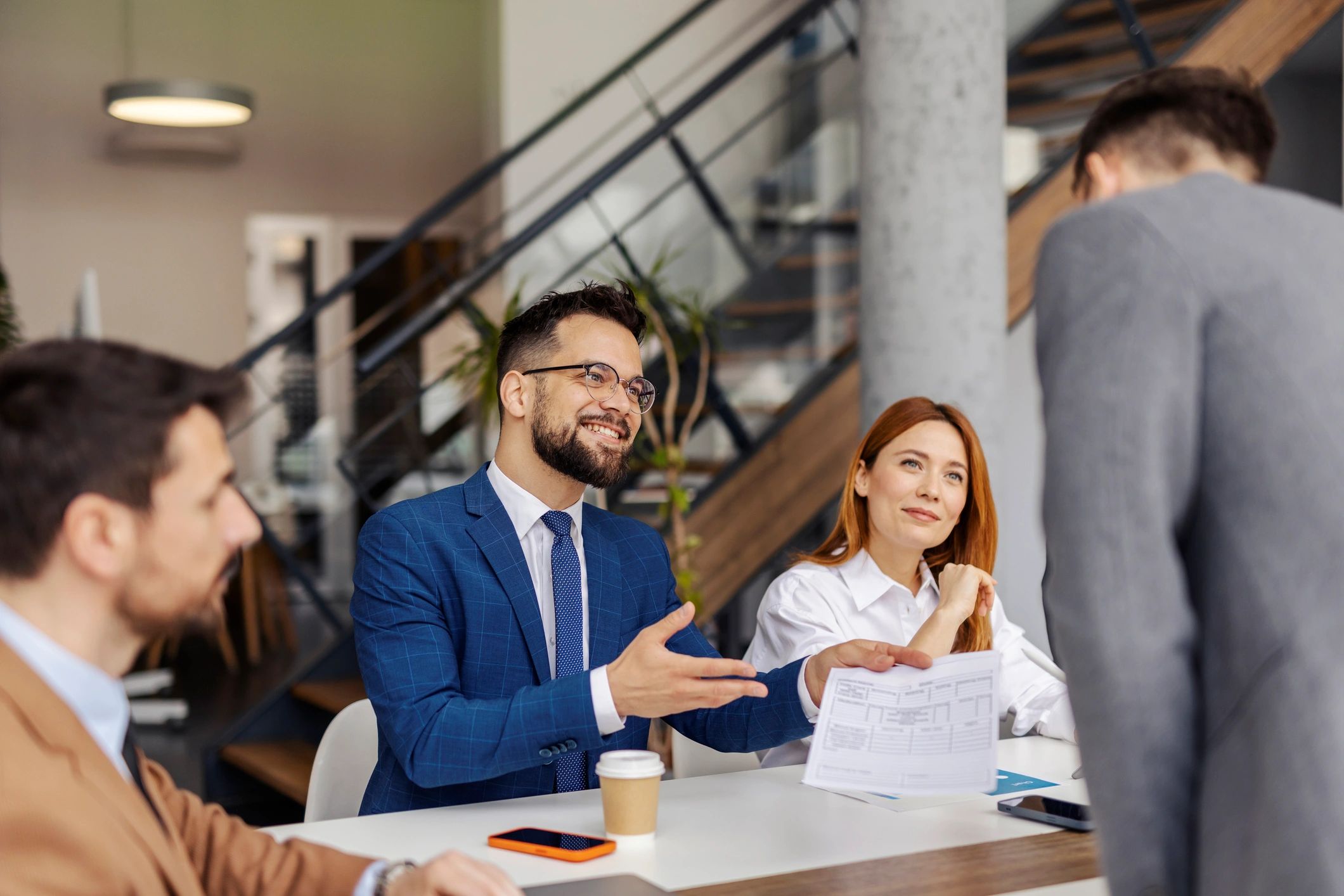 Business professional presenting documents during a meeting